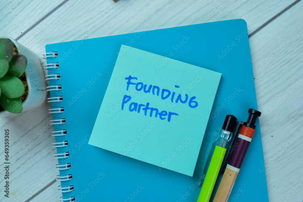 Concept of Founding Partner write on sticky notes isolated on Wooden Table. Concept of Founding Partner write on sticky notes isolated on Wooden Table.