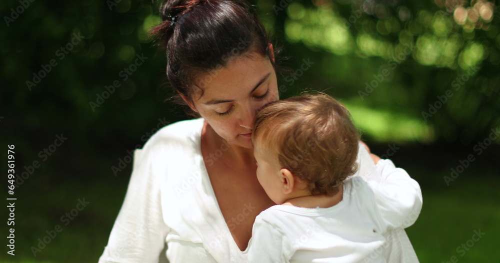 Mother and baby together outside in nature. Playful mom and infant Mother and baby together outside in nature. Playful mom and infant