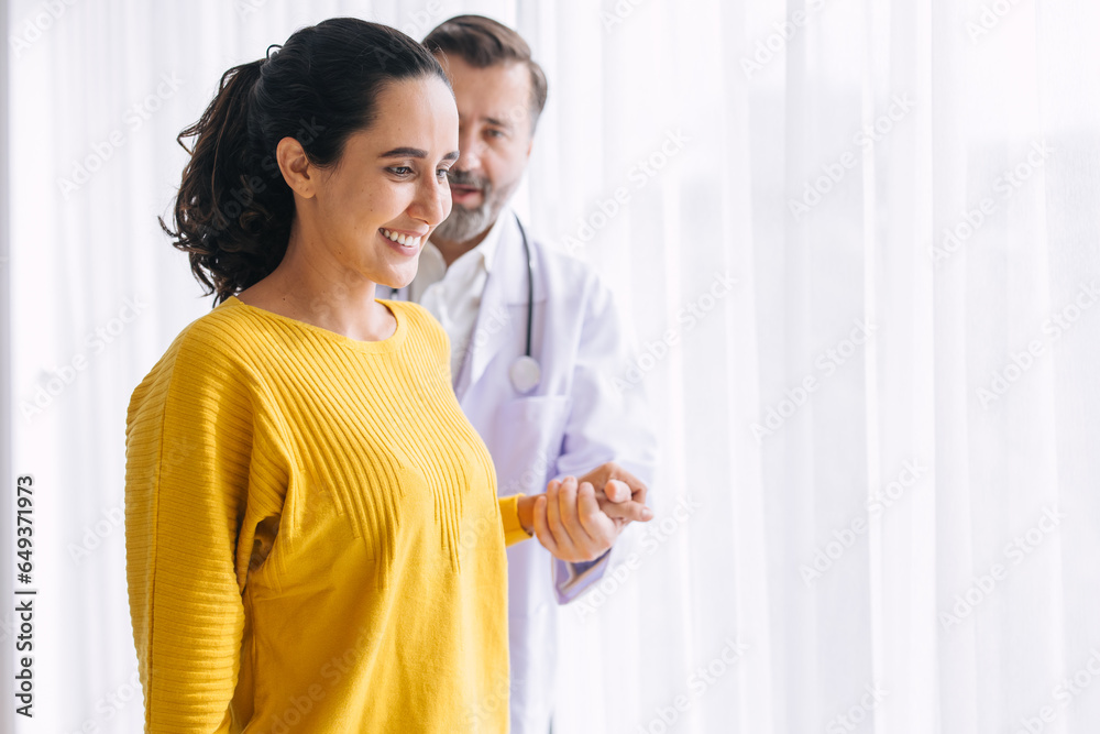 Woman leg injury physical therapy doctor help support try to walk and she very happy after healing and recovery Woman leg injury physical therapy doctor help support try to walk and she very happy after healing and recovery