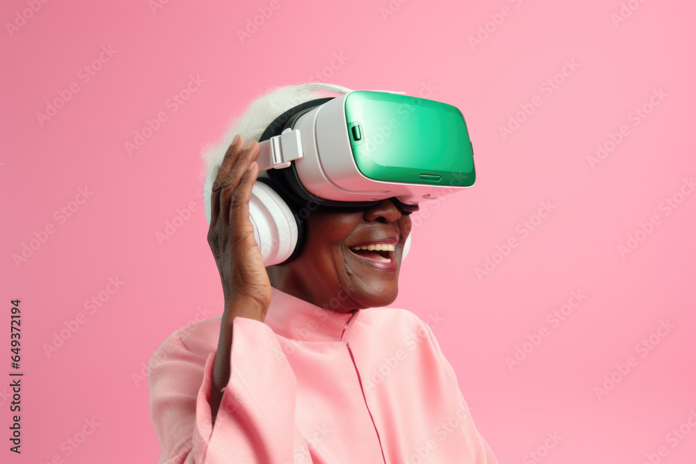 Cheerful elderly african woman wearing VR helmet on pink pastel background. Cheerful elderly african woman wearing VR helmet on pink pastel background.