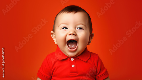 Small child laughing on a red background
