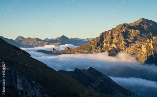 Clouds in the valleys of the Italian alps during a tranquil dawn. © sanderstock