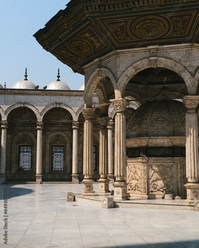 Interior of the courtyard of the Glass Mosque in the ancient city of Cairo, Egypt. Courtyard without people or tourists, with the porticos and the fountain of the circular ablation. Closeup shot.