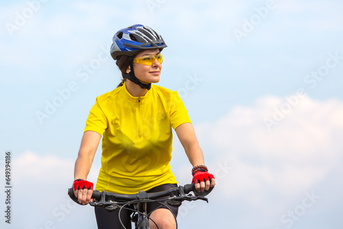 Beautiful woman cyclist in yellow clothes on the bike. sports, hobbies and entertainment for health
