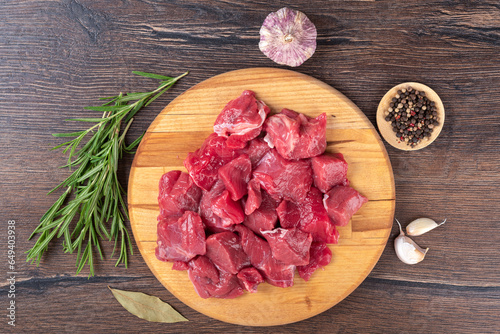 Top view of fresh beef or lamb meat, garlic, rosemary and pepper mixture.