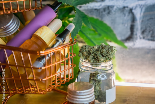 Mini shopping cart with various Medical Cannabis products on table, Shopping purchase concept of Marijuana supplements photo
