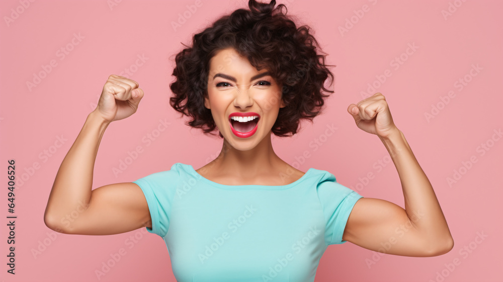 Strong young lady grabs attention as she shows off her muscular biceps and vocalizes her strength.. - obrazy, fototapety, plakaty 