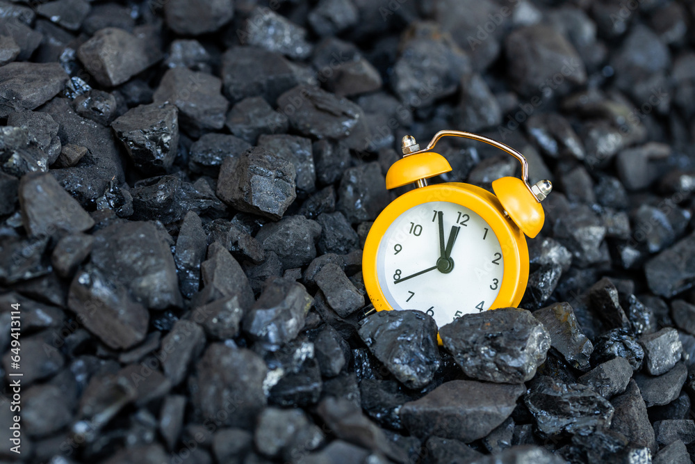 clock with an alarm for the twelve o'clock furnace lying in a coal heap