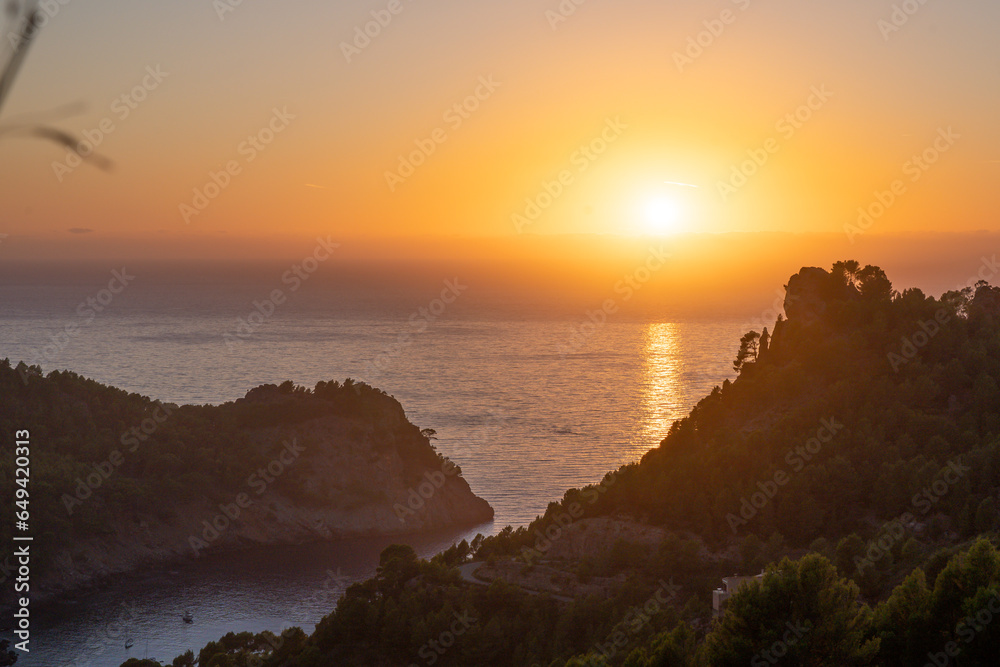 Beautiful view of Sun falling into the sea in Cala Tuent Beautiful view of Sun falling into the sea in Cala Tuent