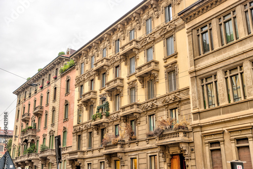 Fototapeta Naklejka Na Ścianę i Meble -  Milan, Italy - July 12, 2022: Residential building facades on the streets of Milan
