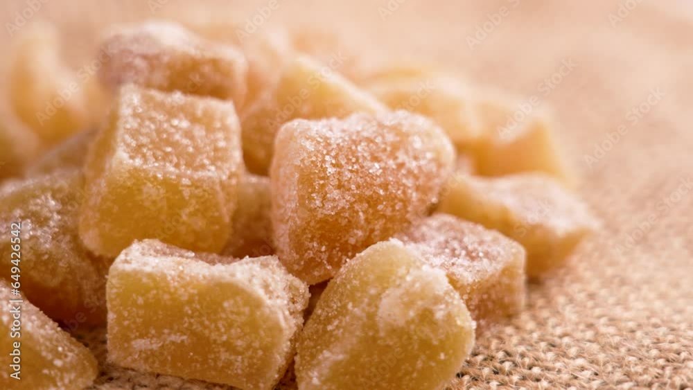 Crystallized candied ginger close up on a rough rustic burlap. Sweet healthy food Crystallized candied ginger close up on a rough rustic burlap. Sweet healthy food