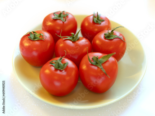 Group of whole tomatoes on plate © Zsolt Biczó