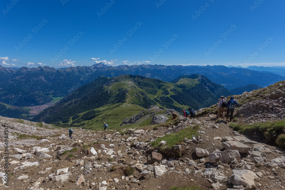 Unrecognizable trekkers go down the path from Torre di Pisa Hut. Latemar Massif, UNESCO world heritage site, Trentino-Alto Adige, Italy, Europe Unrecognizable trekkers go down the path from Torre di Pisa Hut. Latemar Massif, UNESCO world heritage site, Trentino-Alto Adige, Italy, Europe