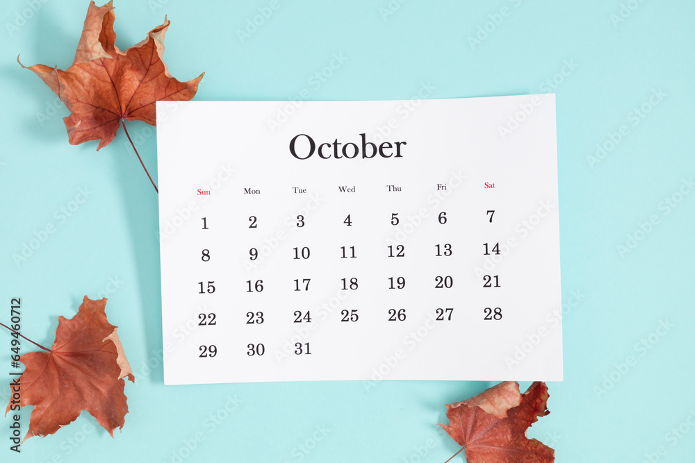 October 2023 monthly calendar maple leaf decoration on pastel blue background. Autumn, fall concept. Flat lay, top view, copy space - obrazy, fototapety, plakaty 