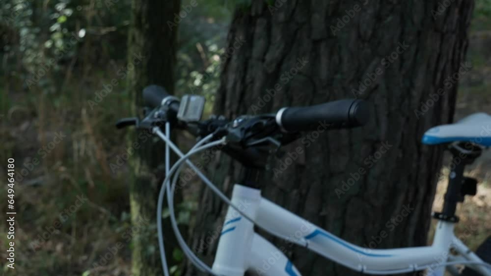 Cyclist inflating tires in the forest near a tree. Problems with a bicycle wheel on a walk in the park. 4k Cyclist inflating tires in the forest near a tree. Problems with a bicycle wheel on a walk in the park. 4k