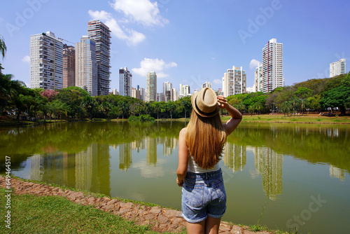 Visiting Goiania, Brazil. Rear view of beautiful girl in Parque Sulivan Silvestre also known as Parque Vaca Brava, a city park in Goiania, Goias, Brazil. photo