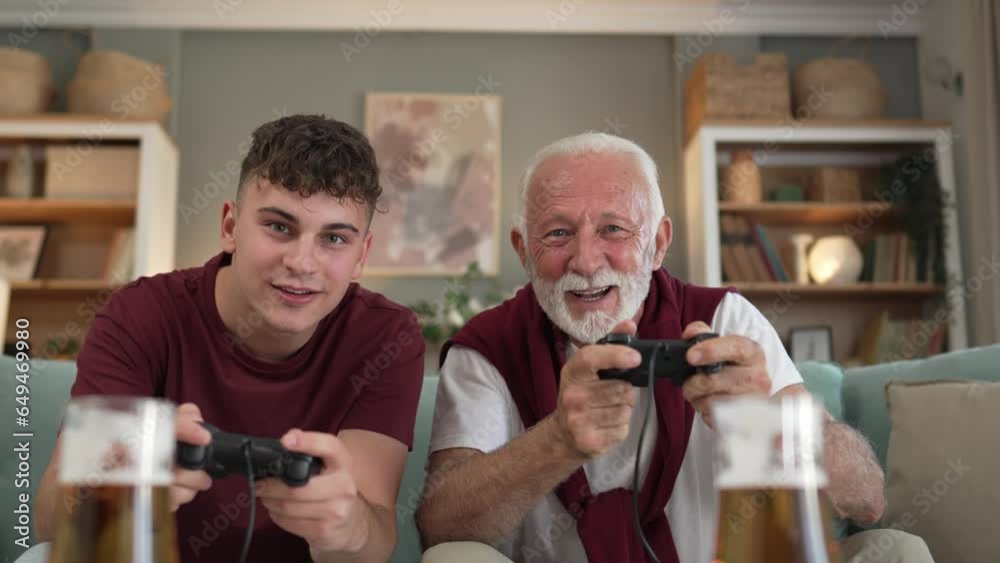 teenager male and his grandfather senior man play console video game teenager male and his grandfather senior man play console video game
