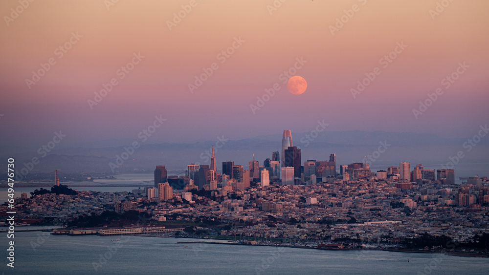 San Francisco skyline at sunset with full moon.