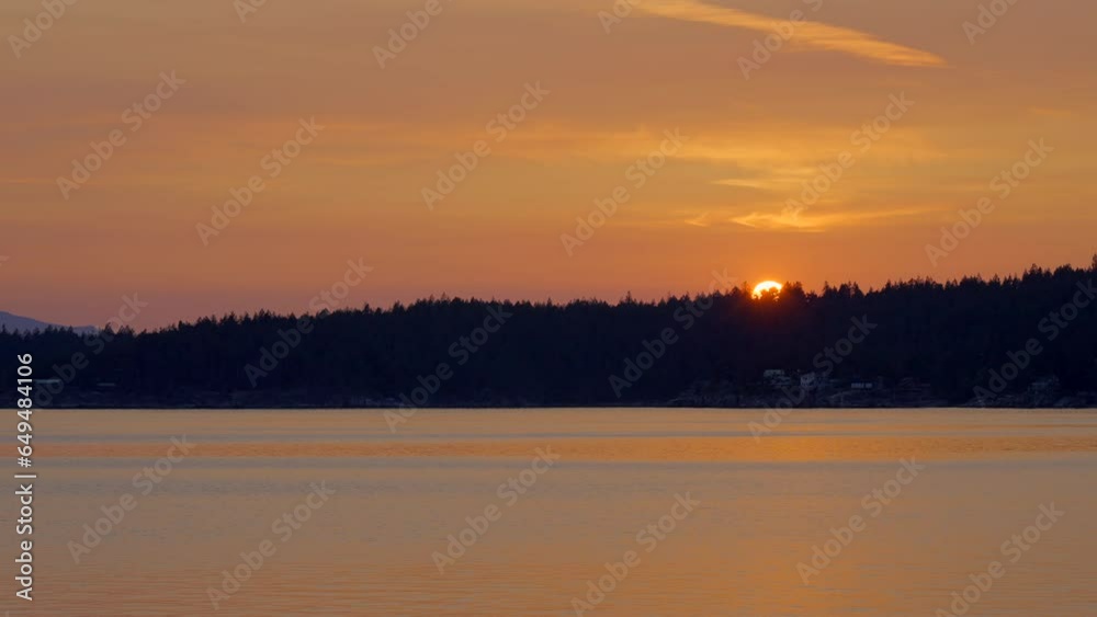 Establishing shot of ocean sunset over mountains in slow motion at summer day in Vancouver, Canada, North America. Evening time on September 2022. Still camera. ProRes 422 HQ. Establishing shot of ocean sunset over mountains in slow motion at summer day in Vancouver, Canada, North America. Evening time on September 2022. Still camera. ProRes 422 HQ.