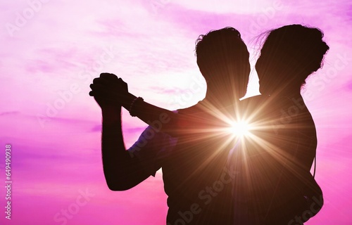 Silhouette Soulmate lover freedom dancing celebration event over romance sunset sky, meeting true love manifestation, twin flames, spiritual couple with Miracle bokeh light.
