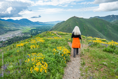 USA, Idaho, Hailey, Senior blonde woman hiking on Carbonate Mountain trail photo