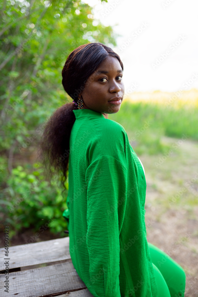 Woman wearing green blouse, looking over shoulder Woman wearing green blouse, looking over shoulder