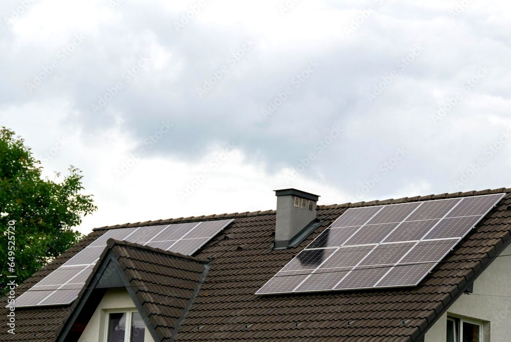 Historic farm house with modern solar panels on roof and wall