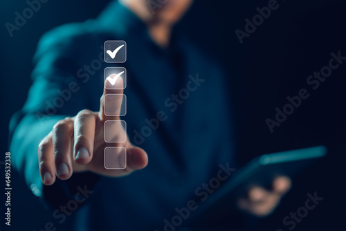 the person holding a tablet ticks the checkmark in the box. on the list of documents. the concept of check form online, checklist process order. business verify task detail and evaluation tick mark