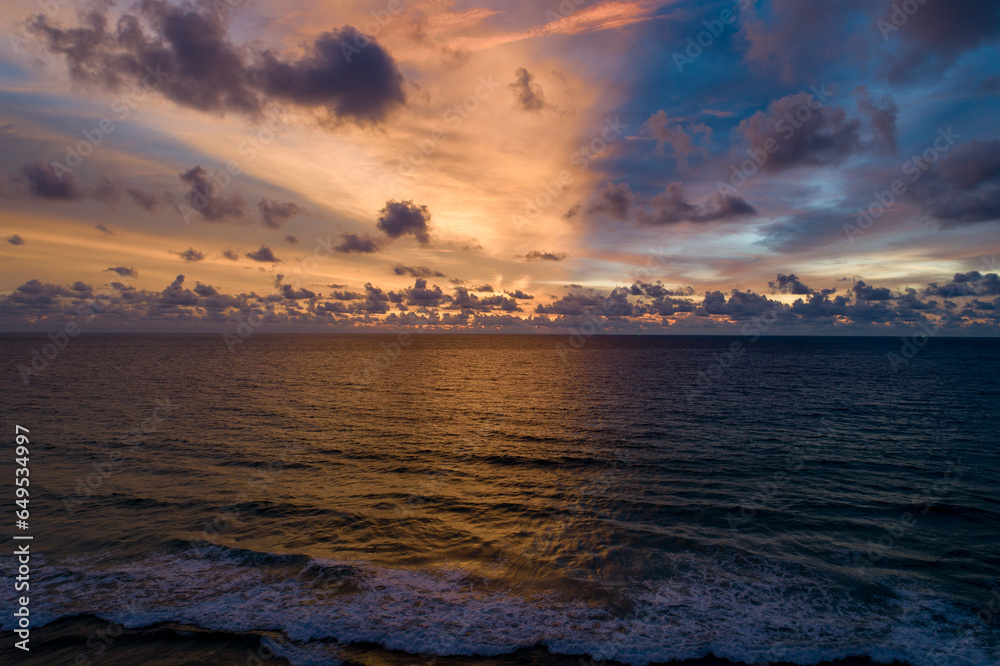 Fototapeta premium Aerial view sunset sky over sea,Nature Light Sunset or sunrise over ocean,Colorful dramatic scenery sky, Amazing clouds and waves in sunset sky beautiful light nature background