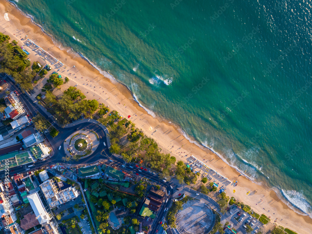 Aerial view of cars with road along the beach at Phuket island Thailand, Beautiful beach sea in summer season,Amazing light sunset or sunrise,Nature and Travel background