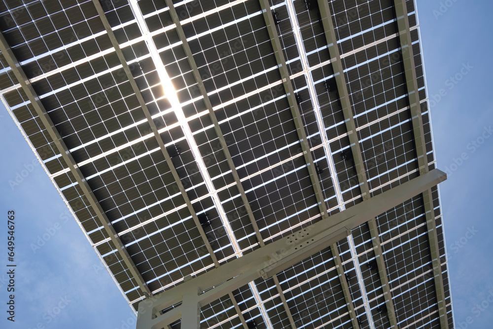 Solar panels installed over parking lot canopy shade for parked cars for effective generation of clean energy Solar panels installed over parking lot canopy shade for parked cars for effective generation of clean energy