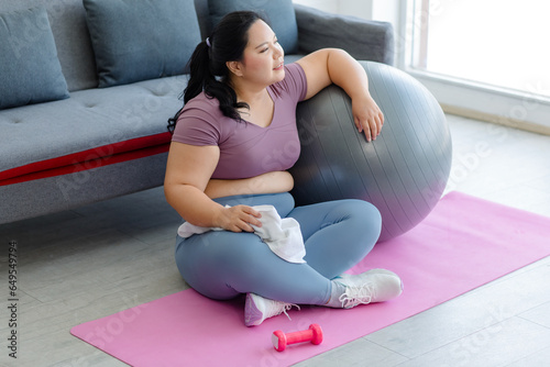 Fotografie Asian young tired exhausted overweight oversized fat chubby plump female sportsw