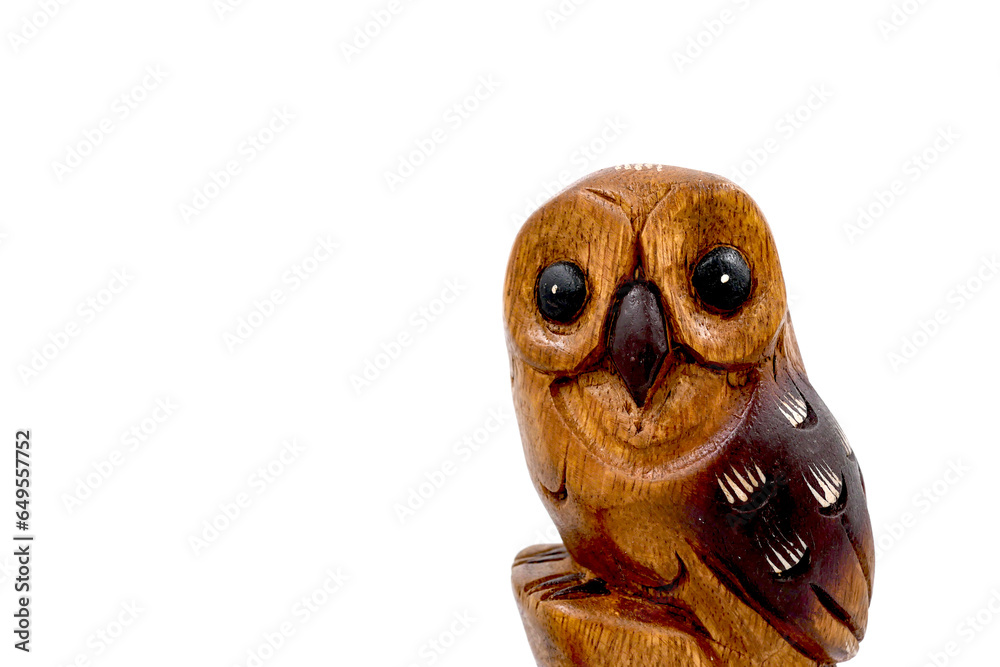 Fototapeta premium Wooden owl (Strigiformes) carved from wood, handcrafted. copy space. isolated on white. Front view.