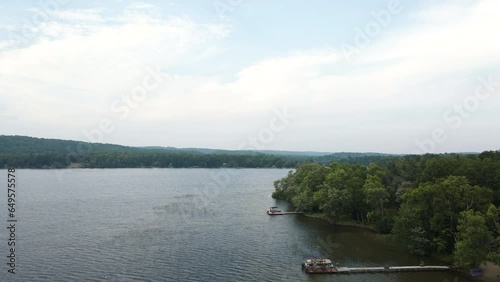 Aerial pedestal above private docks on lake shore on cloudy day photo