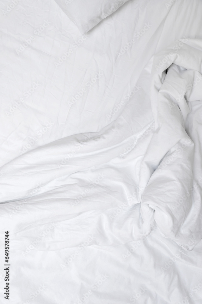 Obraz premium Aesthetic neutral white crumpled cotton textile background. Messy bedding, blanket and sheet