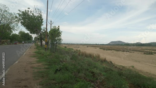 Long stretch of sacred Falgu River dry waterbed with a long stretch of sand dunes alongside the city road, Bodhgaya, Bihar, India photo