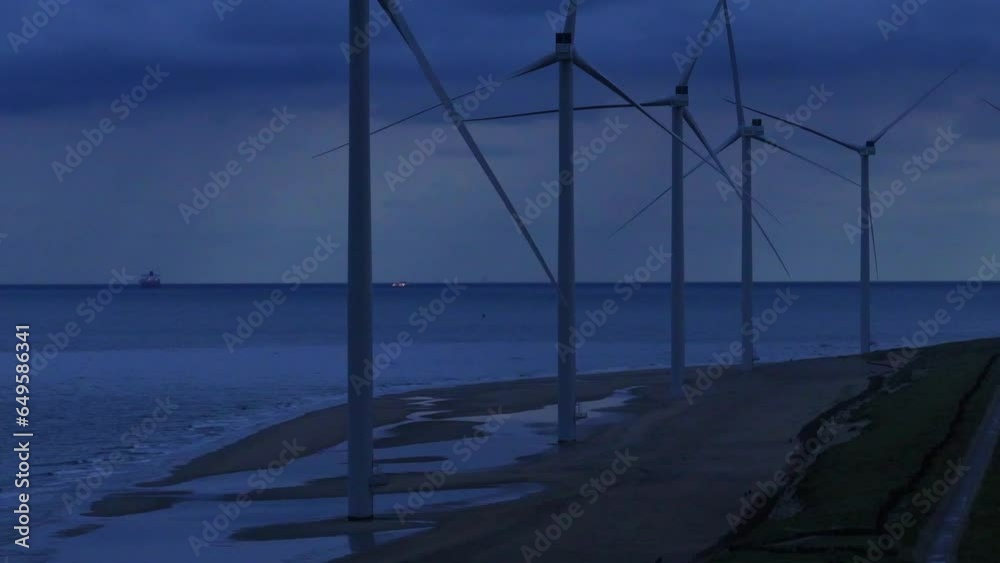 Seaside at blue hour. Wind turbines stationary. Nature and industry. Seaside at blue hour. Wind turbines stationary. Nature and industry.