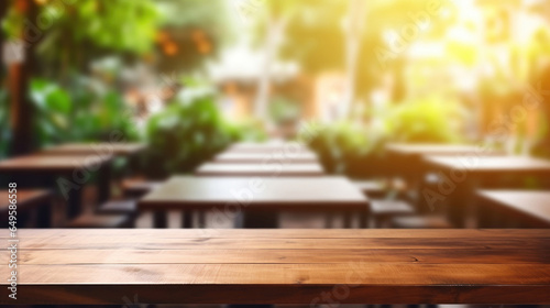 Wooden board empty table in front of blurred coffee shop background © tashechka
