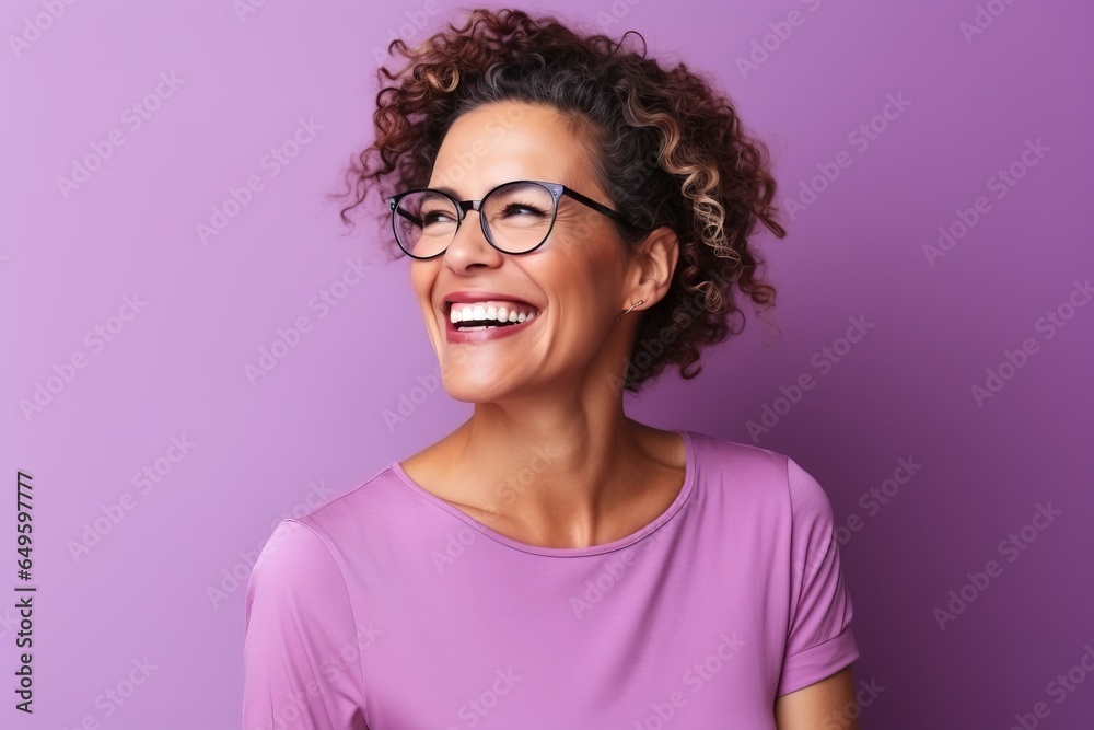 Portrait of a beautiful young african american woman with curly hair and glasses smiling against purple background - obrazy, fototapety, plakaty 