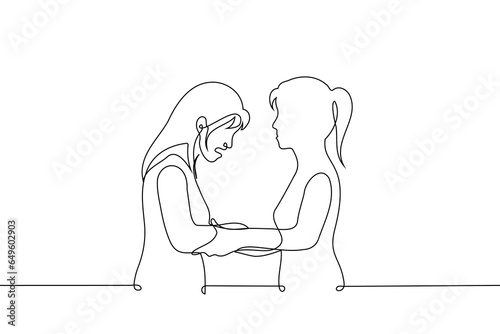 woman holding hands of crying woman - one line art vector. concept woman comforts, consoles, calms woman, sisters or female friends