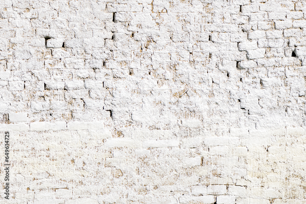 Texture of an old worn white brick wall