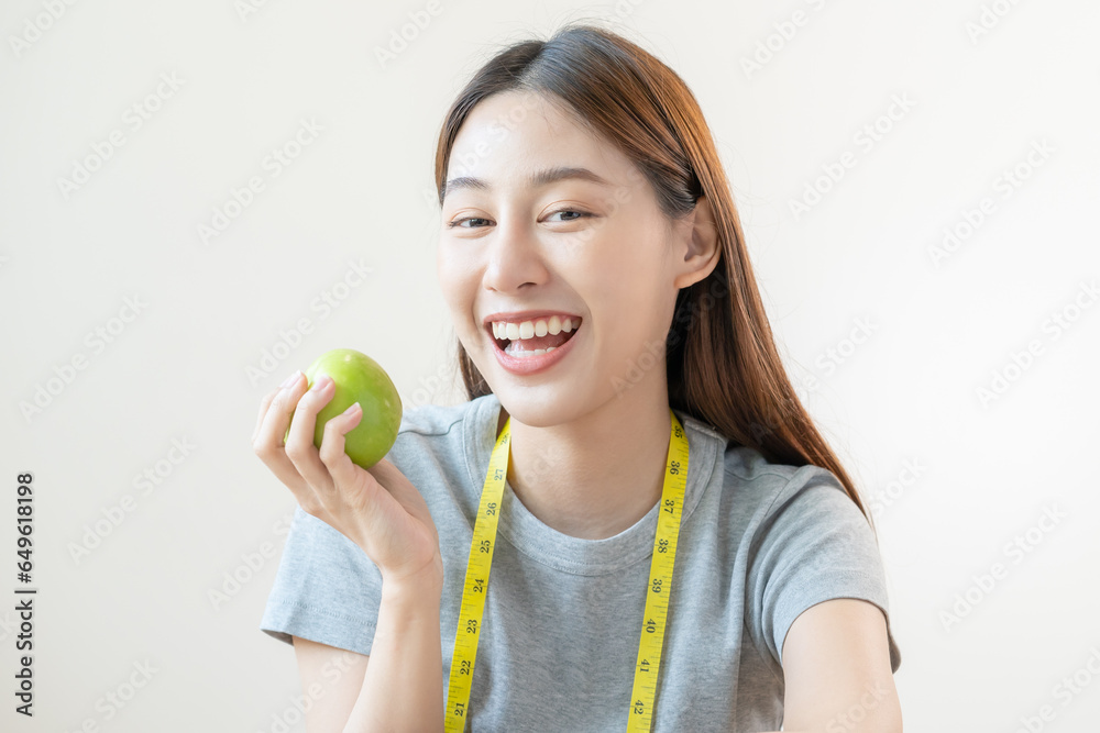 Diet food concept, Close up portrait smile, cheerful asian young woman, girl with healthy teeth, hand holding or eating organic fresh green apple when hungry, isolated on white background healthcare. Diet food concept, Close up portrait smile, cheerful asian young woman, girl with healthy teeth, hand holding or eating organic fresh green apple when hungry, isolated on white background healthcare.