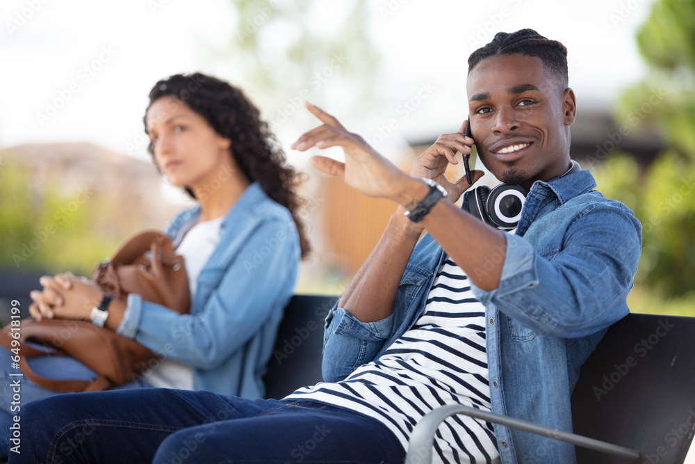 attractive people talking at sitting on bench attractive people talking at sitting on bench