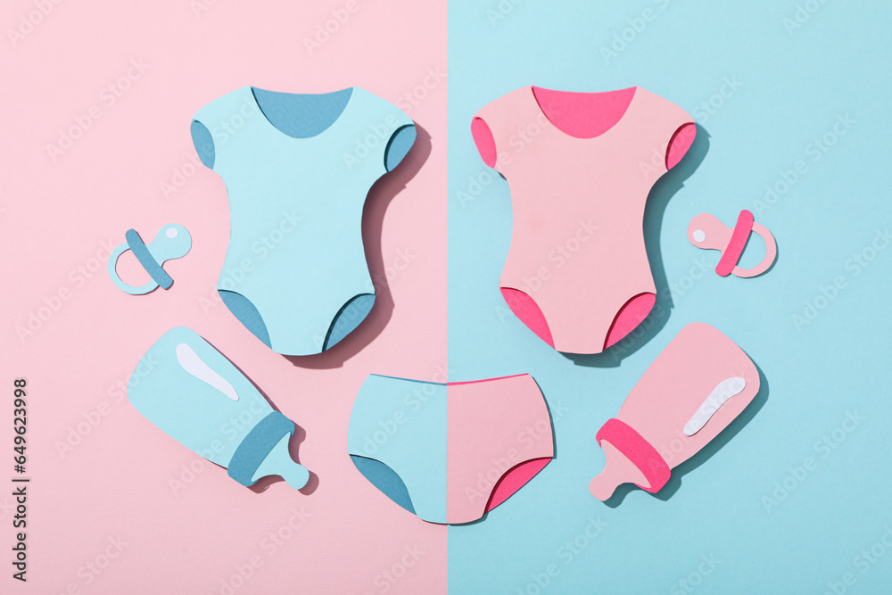 Paper baby things on blue and pink background, top view Paper baby things on blue and pink background, top view