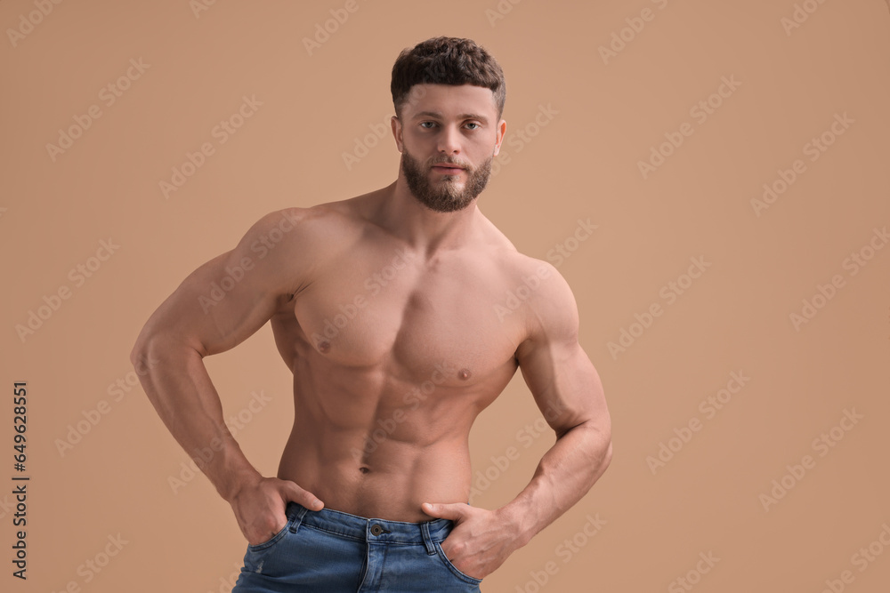 Handsome muscular man on beige background. Sexy body