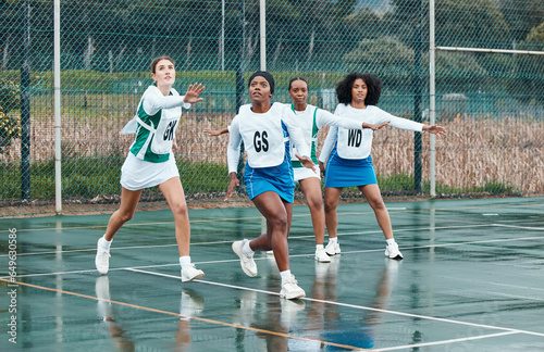Sports, netball team and portrait of women training in competition, game or match. Fitness, group and girls workout on court, exercise and practice performance on wet field outdoor for healthy body