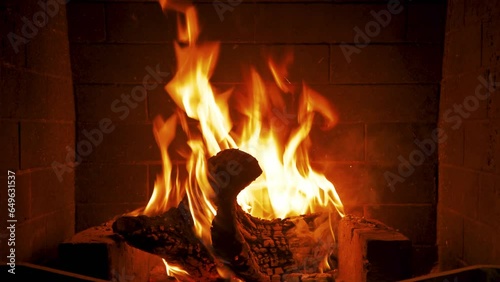 Home fireplace with red flame and firewood. 4K video relaxing endless footage