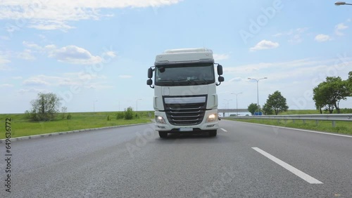 White truck driving along the highway. A modern truck is driving along the highway. Transportation of goods. Logistic services. A tank truck driving along the highway