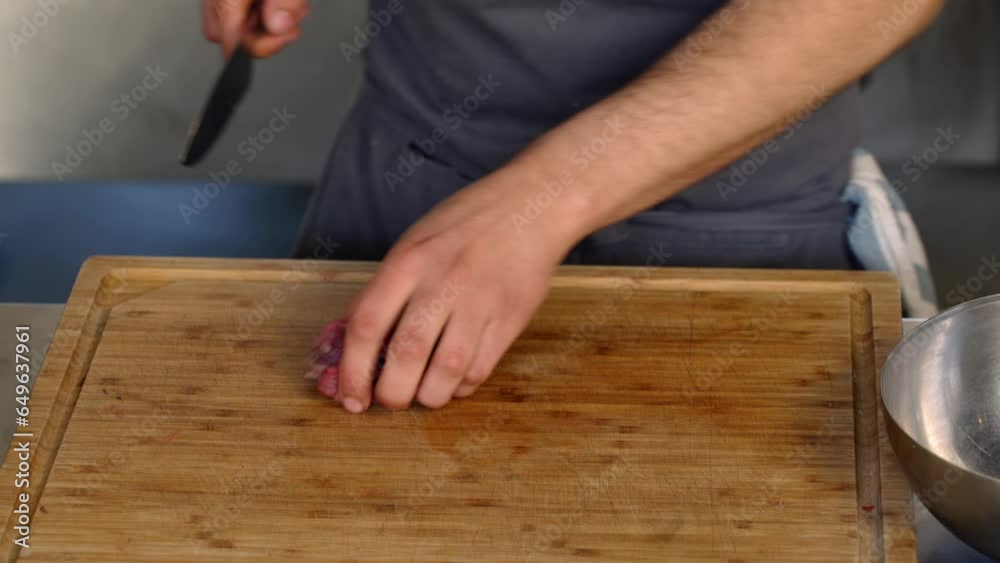 A chef cutting a piece of meat to fine pieces A chef cutting a piece of meat to fine pieces