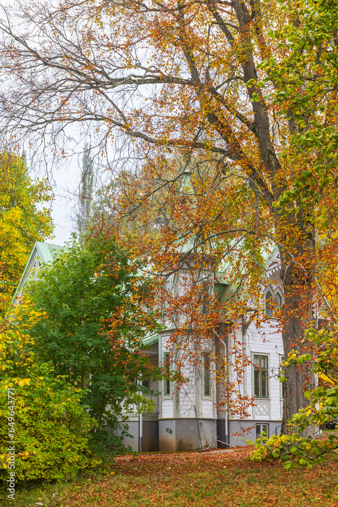 Idyllic house with autumn colors in the garden